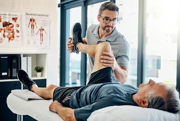 Image of a physiotherapist helping a patient